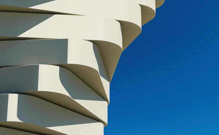 Abstract architectural structure featuring layered white geometric forms against a vivid blue background, symbolising modern infrastructure, innovation and scalable technology