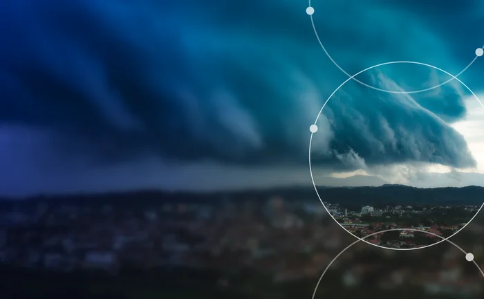 Storm clouds over a city illustrating physical climate risk and extreme weather