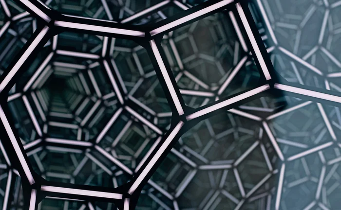 Illuminated geometric lattice forming an abstract futuristic network tunnel