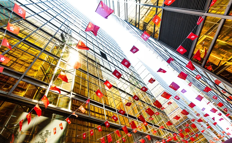 Chinese-and-Hong-Kong-flags-connecting-buildings
