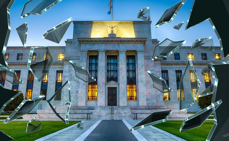 Federal Reserve building with shards of shattered glass around it