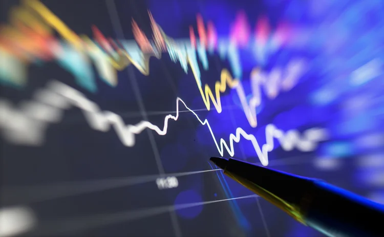 Pen pointing at a trading screen