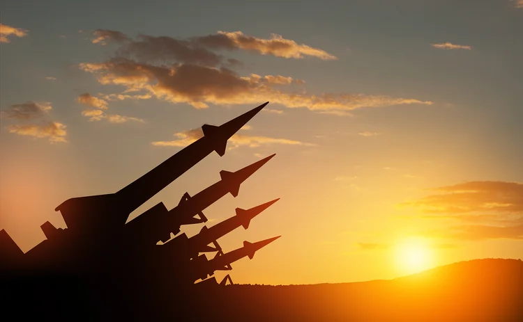 Sunset silhouette of missiles aimed into the sky