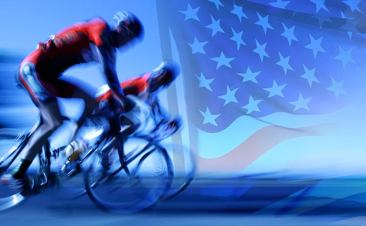 Cyclists neck and neck against US flag