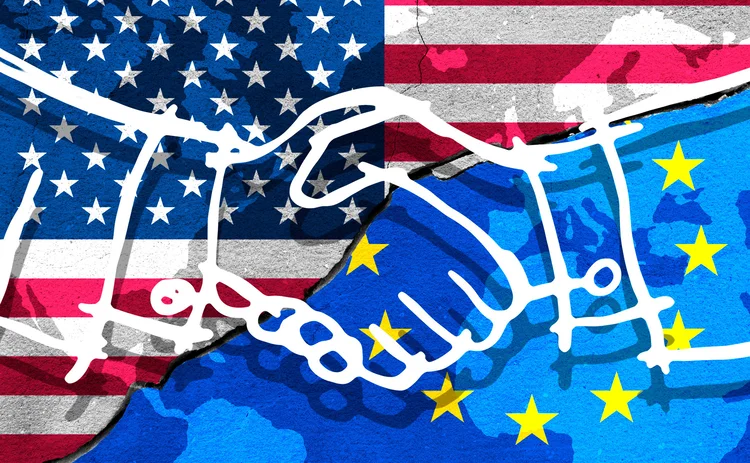 EU and US flags in background with two hands shaking in the foreground