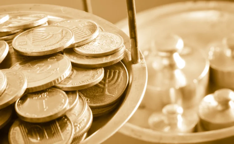 image of coins being weighed