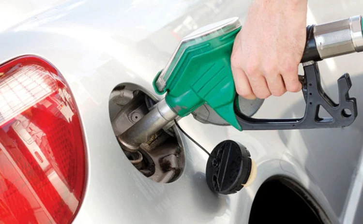 A man pumping gas in to a car tank