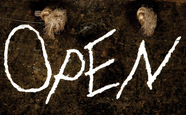 close-up-of-homemade-old-open-sign-hanging-on-rope