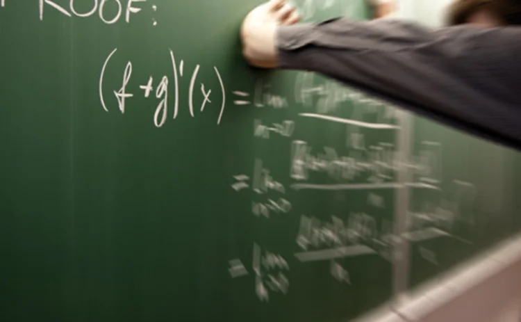 Frustrated man at the blackboard during a maths class