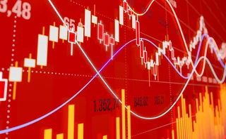 Red stock market chart with candlesticks and trend lines showing market volatility