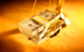 Dollar notes are on a weighing scale