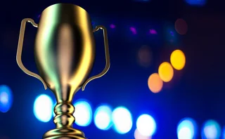 A gold trophy with a blue background