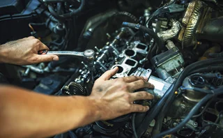 Mechanic fixing car engine