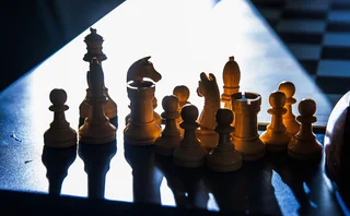 Chess pieces on a chess board, indicating endgame