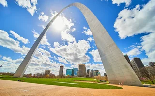Low angle of arch in St Louis, Missouri with skycrapers in background