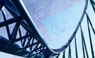 Rollercoaster against a background of euro notes