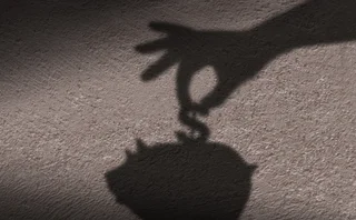 Shadow of a piggy bank with a hand and dollar sign