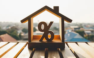 Model of a house containing a percentage sign