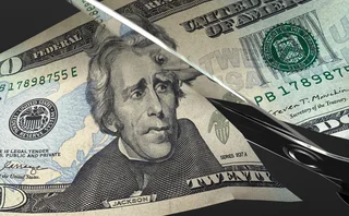 Scissors cut a US $20 bill