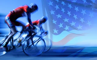 Cyclists neck and neck against US flag