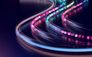 An illuminated, curving tracks suggest speed, adaptability, and continuous progress, while the glowing data-like elements evoke digital communication and technological exchange.