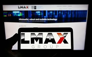 Mobile phone and computer screen with LMAX logo and website