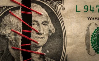 Two pieces of dollar banknote being stitched together