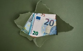 A paper package has been ripped open, revealing euro notes 