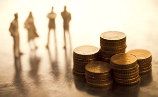 Small figures looking at piles of coins