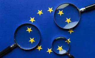 Three magnifying glasses scrutinise the EU flag