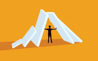 Illustration of a man holding up some falling structures