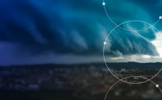 Storm clouds over a city illustrating physical climate risk and extreme weather