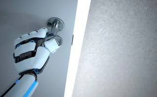 A humanoid robot’s hand opens a door 