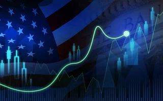 US-flag behind rising candlestick chart
