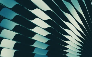 Abstract close-up featuring flowing curved lines in deep teal, black, and pale blue tones, creating a modern geometric pattern with contrasting highlights and shadows.