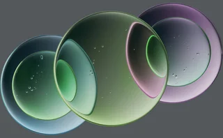 Abstract illustration of overlapping translucent green, blue and purple circular shapes