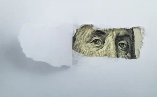 Torn white paper revealing US Currency - stock photo