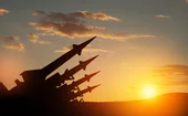 Sunset silhouette of missiles aimed into the sky