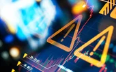 Warning signs over background of erratic chart data on a screen