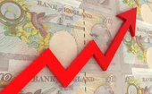 Pound notes with a red upward arrow