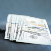 Dollars with ball and chain