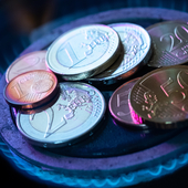 Euro coins on gas hob