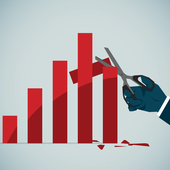 Hand holding scissors cutting down a graph