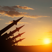 Sunset silhouette of missiles aimed into the sky