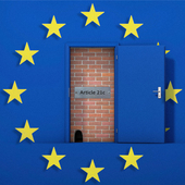 A brick wall behind a door has been broken down
