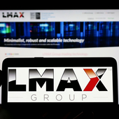 Mobile phone and computer screen with LMAX logo and website