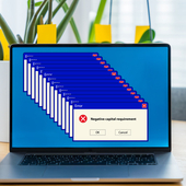 Error message on a laptop screen reads ‘negative capital requirement’