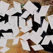 Exam papers fly randomly in front of a backdrop of the strait of hormuz