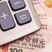 Calculator on top of Hong Kong dollar banknotes