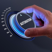 A dial with automation written on it is turned to 100% by a hand